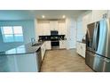 Modern kitchen boasts stainless appliances, a breakfast bar, and stylish tile flooring at 11296 Listening Dr, Orlando, FL 32832
