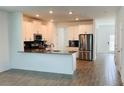 Modern kitchen features stainless steel appliances, granite countertops, and ample cabinet space at 11296 Listening Dr, Orlando, FL 32832