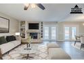 Bright living room with fireplace, built-in shelves, neutral tones, and access to the outdoor at 121 Primrose Dr, Longwood, FL 32779