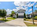 Two-story home showcasing its driveway, landscaping, and curb appeal at 1476 Pine Marsh Loop, St Cloud, FL 34771