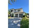 Charming two-story home with a brick driveway and mature landscaping at 1690 Palm Ave, Winter Park, FL 32789