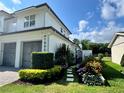 An inviting exterior view showcasing a lush garden and stepping stone pathway at 1690 Palm Ave, Winter Park, FL 32789