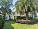 A serene side view of the home with a well-maintained lawn and verdant garden at 1690 Palm Ave, Winter Park, FL 32789