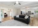 Inviting living area opens to the kitchen and features hardwood floors and a comfortable black sofa at 4701 Goddard Ave, Orlando, FL 32804