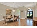Elegant dining room with hardwood floors, chandelier, and a decorative mirror wall at 13710 Lake Cawood Dr, Windermere, FL 34786