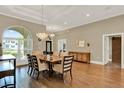 Spacious dining room featuring hardwood floors, chandelier, and a decorative console at 13710 Lake Cawood Dr, Windermere, FL 34786