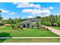 Gorgeous two-story home boasting manicured landscaping, arched windows, and brick driveway at 13710 Lake Cawood Dr, Windermere, FL 34786