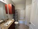 Full bathroom with cherry vanity, granite countertop, and tub with shower at 1420 Lake Shadow Cir # 9207, Maitland, FL 32751