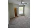 Neutral bedroom featuring carpet, ceiling fan, a large window, and a closet at 1420 Lake Shadow Cir # 9207, Maitland, FL 32751