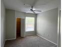 Neutral bedroom featuring carpet, ceiling fan, a large window, and a closet at 1420 Lake Shadow Cir # 9207, Maitland, FL 32751