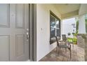 Inviting covered front porch with seating area, ideal for enjoying morning coffee or greeting guests at 14883 Golden Sunburst Ave, Orlando, FL 32827