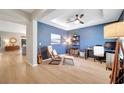 Stylish living room with modern furnishings, accent wall, tray ceiling, and hardwood flooring at 14883 Golden Sunburst Ave, Orlando, FL 32827