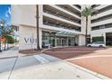 Inviting entrance to the Vue at Lake Eola, featuring well-maintained landscaping and brick-paved drive at 150 E Robinson St # 801, Orlando, FL 32801