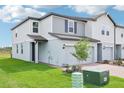 Two-story home shows off a contemporary design with a mix of siding, and a well-manicured lawn at 16430 Bird Of Paradise Ave, Clermont, FL 34714