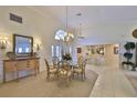 Bright dining room featuring a chandelier and large window, ideal for Gathering gatherings and elegant meals at 2446 Sweetwater Country Club Dr, Apopka, FL 32712