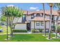 Well-maintained townhome with lush green lawn, mature landscaping and inviting curb appeal at 3106 S Semoran Blvd # P-2, Orlando, FL 32822