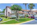 Inviting townhome with well-manicured lawn, mature trees, and colorful landscaping at 3106 S Semoran Blvd # P-2, Orlando, FL 32822