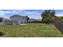 Expansive backyard with a wooden fence, perfect for outdoor activities and relaxation at 8347 Willowwood St, Orlando, FL 32818