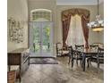 Formal dining room with high ceilings, double doors to the garden, and an elegant chandelier at 8740 Ingleton Ct, Orlando, FL 32836