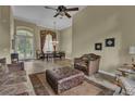 Spacious living room featuring neutral tones, large windows, decorative drapes, and tile flooring at 8740 Ingleton Ct, Orlando, FL 32836