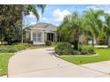 Elegant stone-accented home with well-manicured landscaping, a spacious driveway, and mature trees at 1091 Hampstead Ln, Ormond Beach, FL 32174