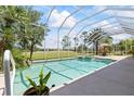 Beautiful screened-in pool and spa with outdoor seating offer a relaxing view of the lawn at 1091 Hampstead Ln, Ormond Beach, FL 32174