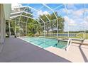 Inviting screened-in pool and spa offer a relaxing oasis with scenic lake views at 1091 Hampstead Ln, Ormond Beach, FL 32174