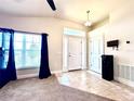 Welcoming foyer featuring tiled floors, a front door with sidelights, and an interior door at 1171 Legatto Loop, Dundee, FL 33838