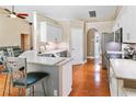 Kitchen with white cabinets, stainless steel appliances, granite counters, and a breakfast bar at 1403 Valley Pine Cir, Apopka, FL 32712