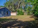 Large backyard with storage shed and mature trees at 15 Estrella Rd, Debary, FL 32713