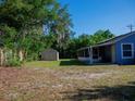 Expansive backyard with storage shed and screened in patio area at 15 Estrella Rd, Debary, FL 32713