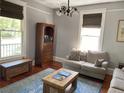 Cozy living room with ample natural light, hardwood floors, comfortable seating, and a decorative area rug at 209 E 4Th St, Sanford, FL 32771