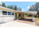 View of the exterior featuring a white covered side patio and a green front door at 2637 Florence St, Orlando, FL 32818