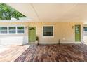 Charming home exterior with a green door, brick paved carport, and ample natural light at 2637 Florence St, Orlando, FL 32818