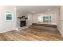 Bright living room with wood floors, decorative fireplace, and elevated adjoining room at 2637 Florence St, Orlando, FL 32818