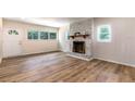 Inviting living room with a brick fireplace and wood-look floors and great natural lighting at 2637 Florence St, Orlando, FL 32818