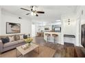 Inviting living room featuring hardwood floors, modern decor, and seamless flow to the kitchen at 3480 Soho St # 107, Orlando, FL 32835