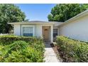 Inviting front entrance with well-maintained landscaping surrounding the walkway to the front door at 4306 Pebblestone Ct, Orlando, FL 32826