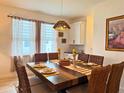 Cozy dining room with a modern chandelier, perfect for Gathering meals at 5637 Beggs Road, St Cloud, FL 34771