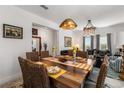 Elegant dining area featuring a rustic wood table, woven chairs, and stylish pendant lighting at 5637 Beggs Road, St Cloud, FL 34771