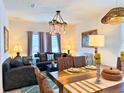 Inviting living room features elegant decor, a modern chandelier, and comfortable seating at 5637 Beggs Road, St Cloud, FL 34771