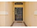 Inviting entryway with a dark front door and neutral tile flooring, creating a welcoming atmosphere at 650 Old Bridge Cir, Davenport, FL 33897