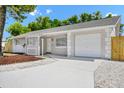 Inviting single-story home featuring a fresh exterior paint job, an attached one-car garage, and meticulous landscaping at 4710 Hatteras Ct, Orlando, FL 32808