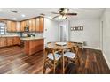 Eat-in kitchen featuring wooden cabinets, granite countertops, stainless appliances, and wood floors at 1026 Manchester Cir, Winter Park, FL 32792
