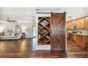 Spacious living area with hardwood floors, open shelving and a sliding barn door at 1026 Manchester Cir, Winter Park, FL 32792