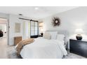 Well-lit bedroom featuring a bed with white linens and modern black accents at 1134 Shaffer Trl, Oviedo, FL 32765