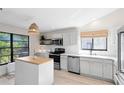 Bright kitchen with white cabinetry, stainless steel appliances, and butcher block island countertop at 1134 Shaffer Trl, Oviedo, FL 32765