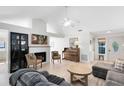 Bright living room with vaulted ceilings, fireplace, piano, and hardwood floors at 1134 Shaffer Trl, Oviedo, FL 32765