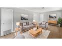 Cozy living room with hardwood floors, gray sofa and armchair, and a decorative coffee table at 1249 12Th St, Clermont, FL 34711