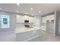 Modern kitchen with white cabinetry, granite countertops, stainless appliances, and center island sink at 1360 Twelve Oaks Rd, St Cloud, FL 34771